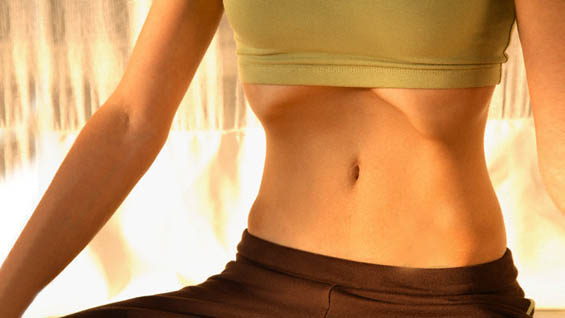 Woman Practicing Uddiyana Bandha at Shreyas Yoga Retreat